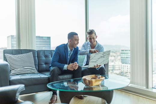 two men in a meeting in a penthouse office